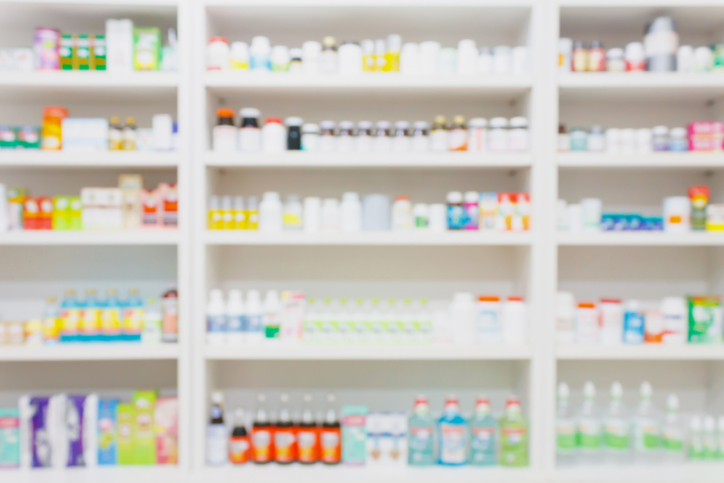 medicines arranged on shelves in the pharmacy blurred background