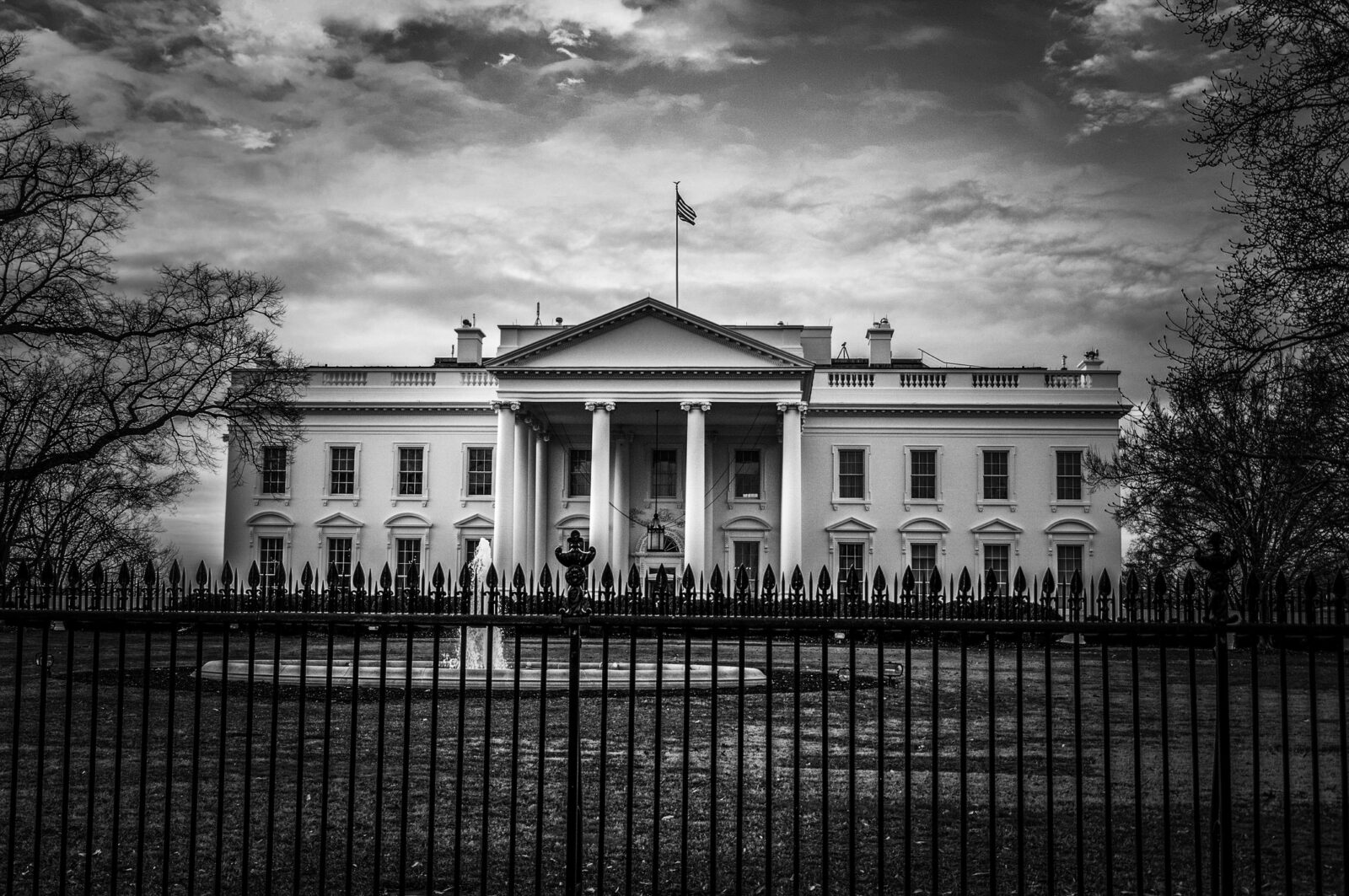 View of the front entrance to the White House in Washington DC with iron fence in the foreground