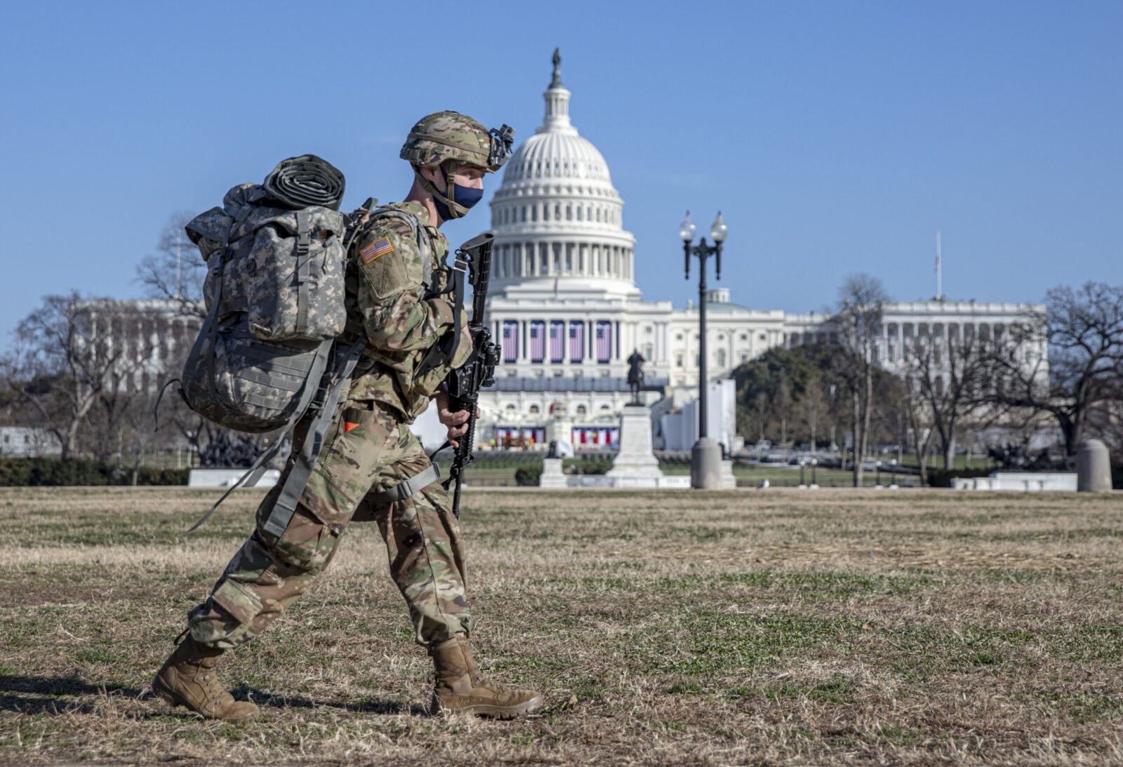 national guardsmen walks pass the Capitol