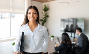 Hispanic female business professional in office boardroom