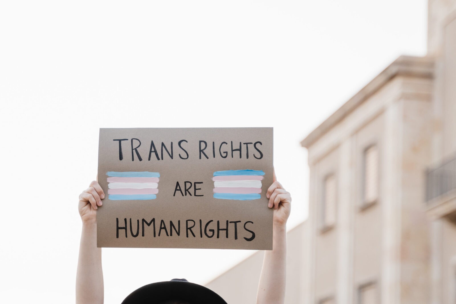 Trans woman at gay pride protest holding transgender flag banner - Lgbt celebration event concept